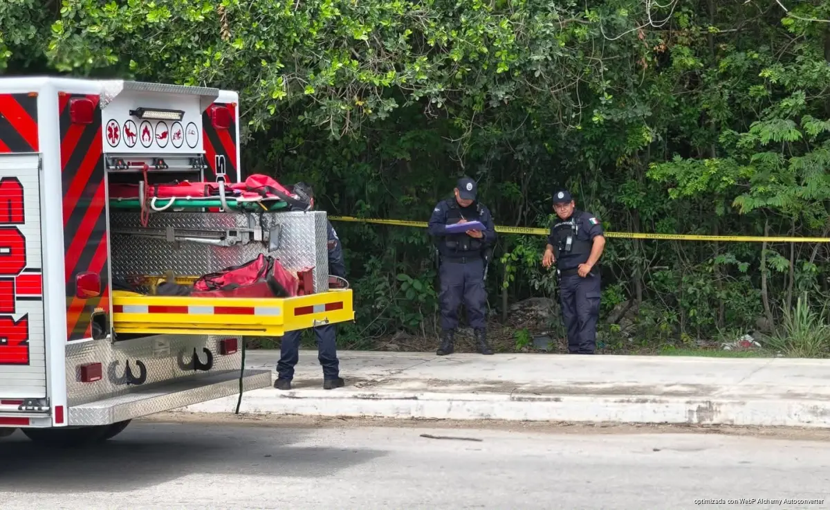 Police officers stand guard near the Arco Vial in Playa del Carmen after the body of a man was found in the area