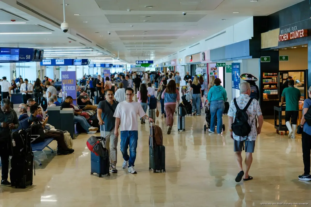 Travelers walking through the terminal at Cancún International Airport
