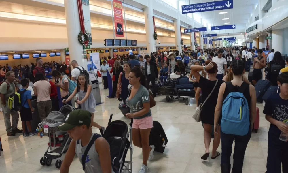 Travelers walking through the terminal of Cancun International Airport in Quintana Roo, Mexico