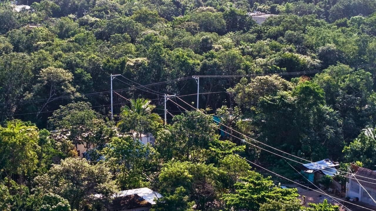 Electrical workers install meters in the Los Lirios neighborhood of Cancun.