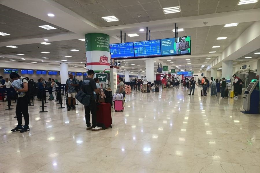 Travelers walking through the terminal at Cancún International Airport in Quintana Roo, Mexico