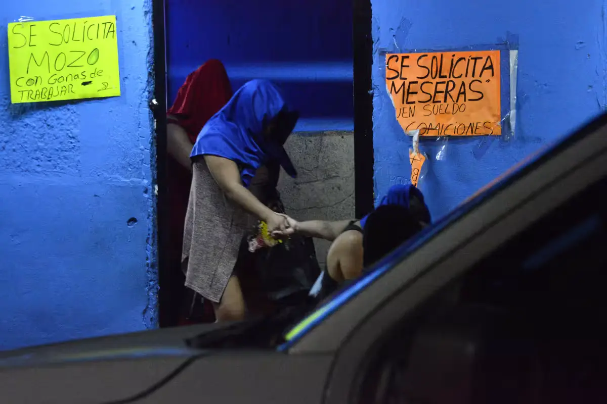 Mexican Navy personnel and state investigators outside a restaurant in downtown Cancún raided over suspected human trafficking