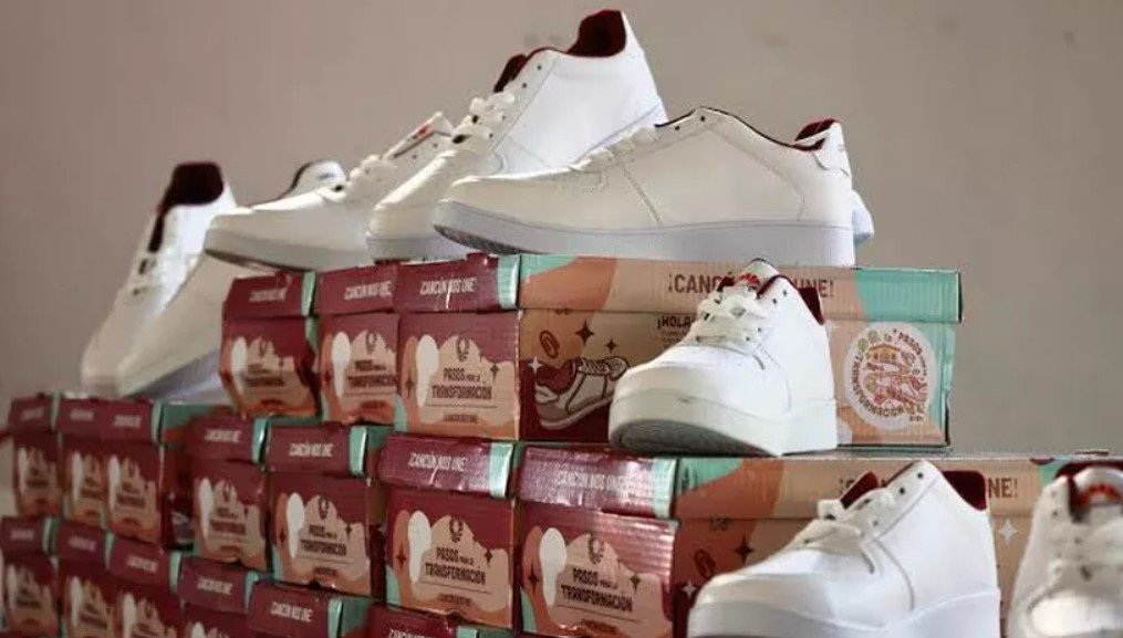 Municipal workers in Cancún prepare boxes of free school sneakers for distribution to public school students