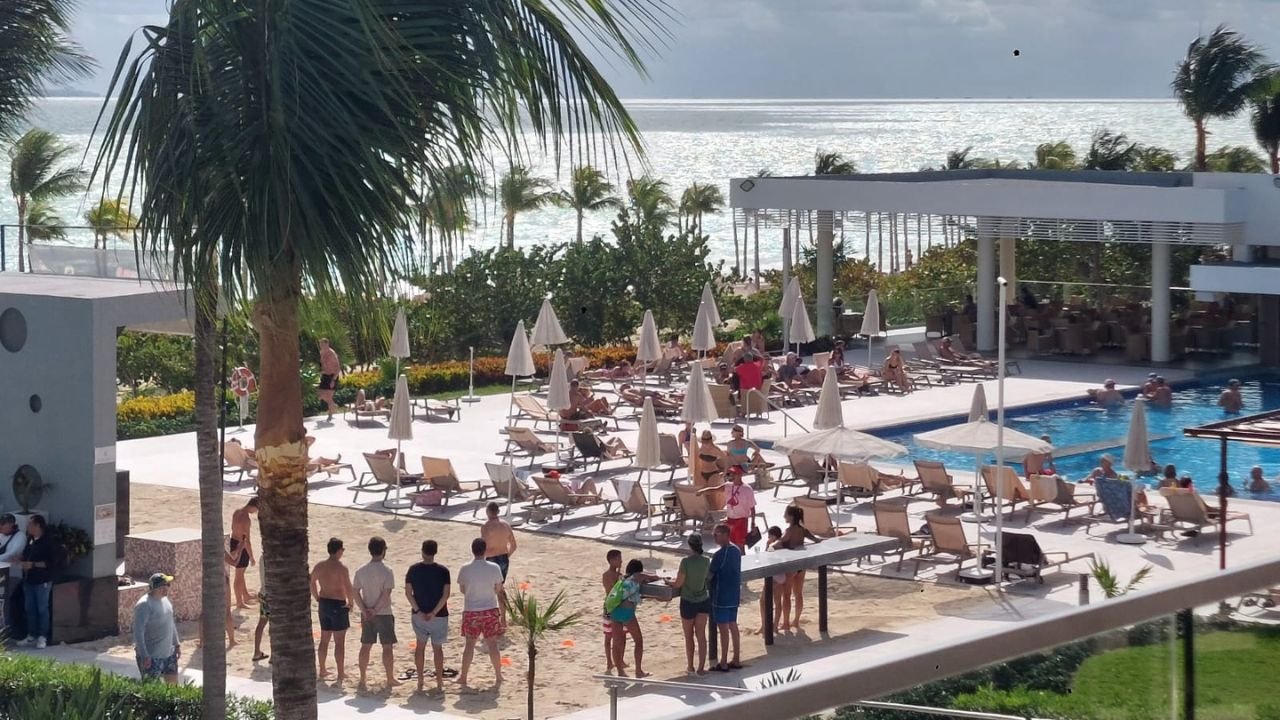 Costa Mujeres resort area with hotel buildings, swimming pools and the Caribbean Sea.