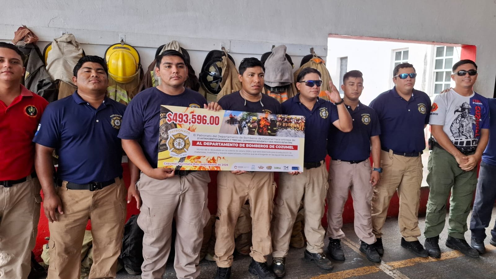 Cozumel firefighters and officials at a fundraising handover ceremony