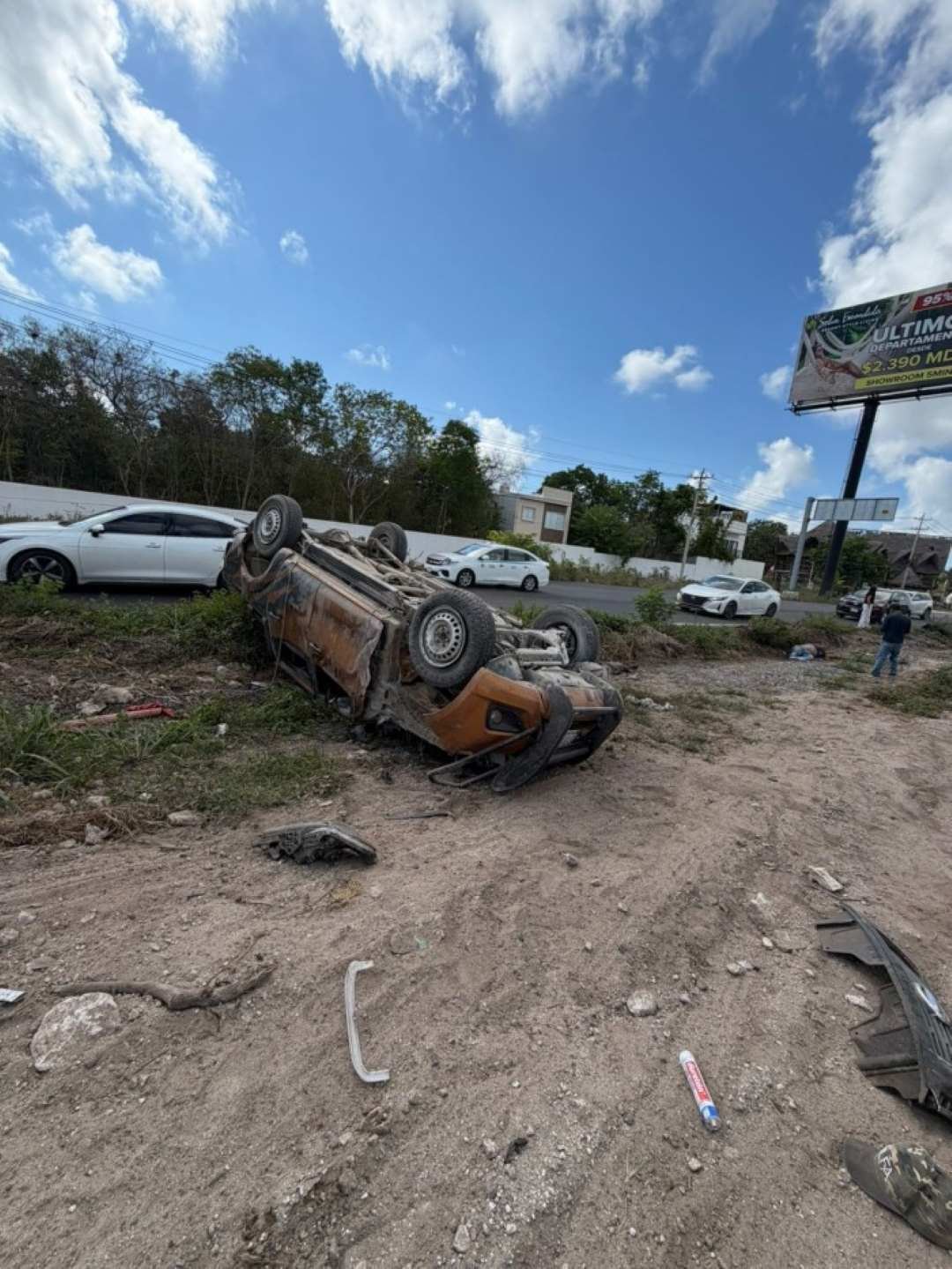 Emergency responders work at the scene of a deadly pickup truck rollover on the Puerto Morelos-Cancún highway.