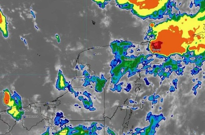 Storm clouds over the Caribbean coast of Quintana Roo with heavy rain falling on a beach town