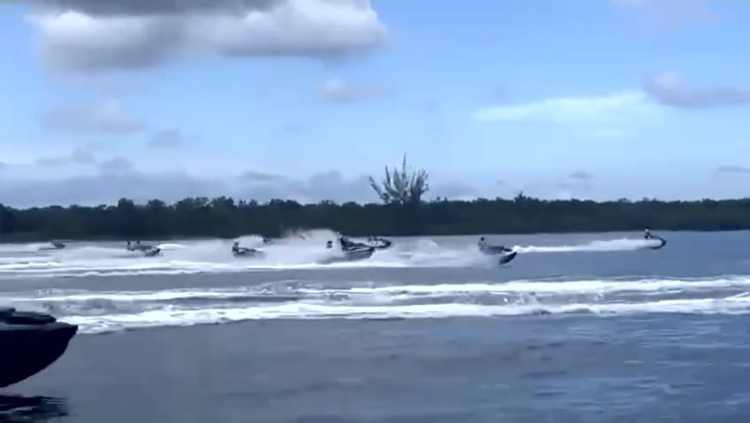 Jet skis speeding across the water near the coral reefs off Cozumel, Quintana Roo