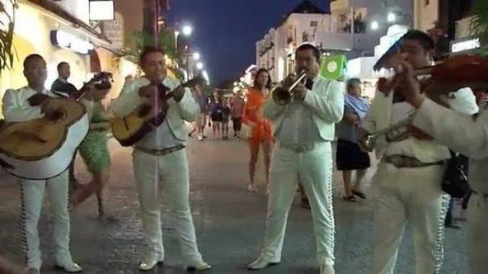 Mariachi musicians in traditional charro suits performing in Playa del Carmen, Quintana Roo