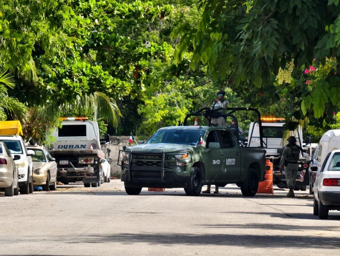 Motorcycles lined up outside a home in Playa del Carmen that authorities say operated as a clandestine repair shop for stolen bikes
