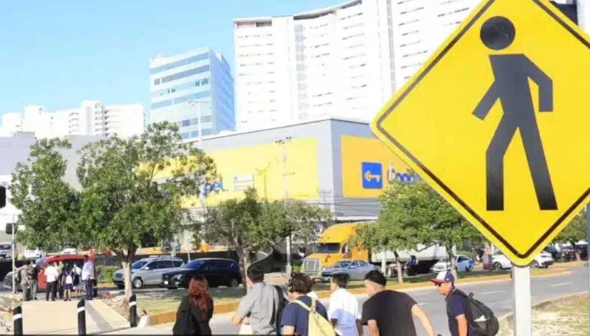 Traffic signs and road markings on a Cancún street as part of a citywide signage program