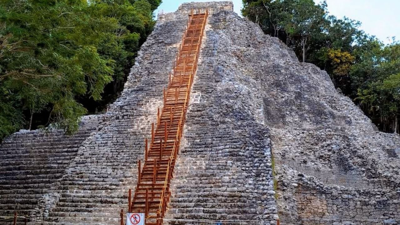 The Nohoch Mul pyramid at Coba, where a modern wooden structure was placed over the original steps.