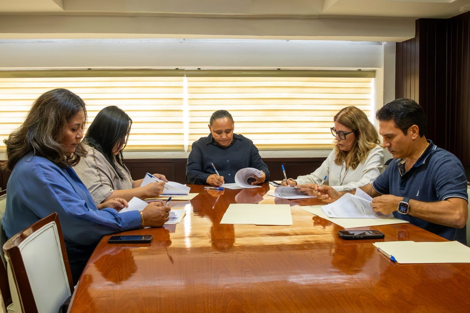 Officials from the Quintana Roo government and Notaries Council pose after signing an agreement for the will program