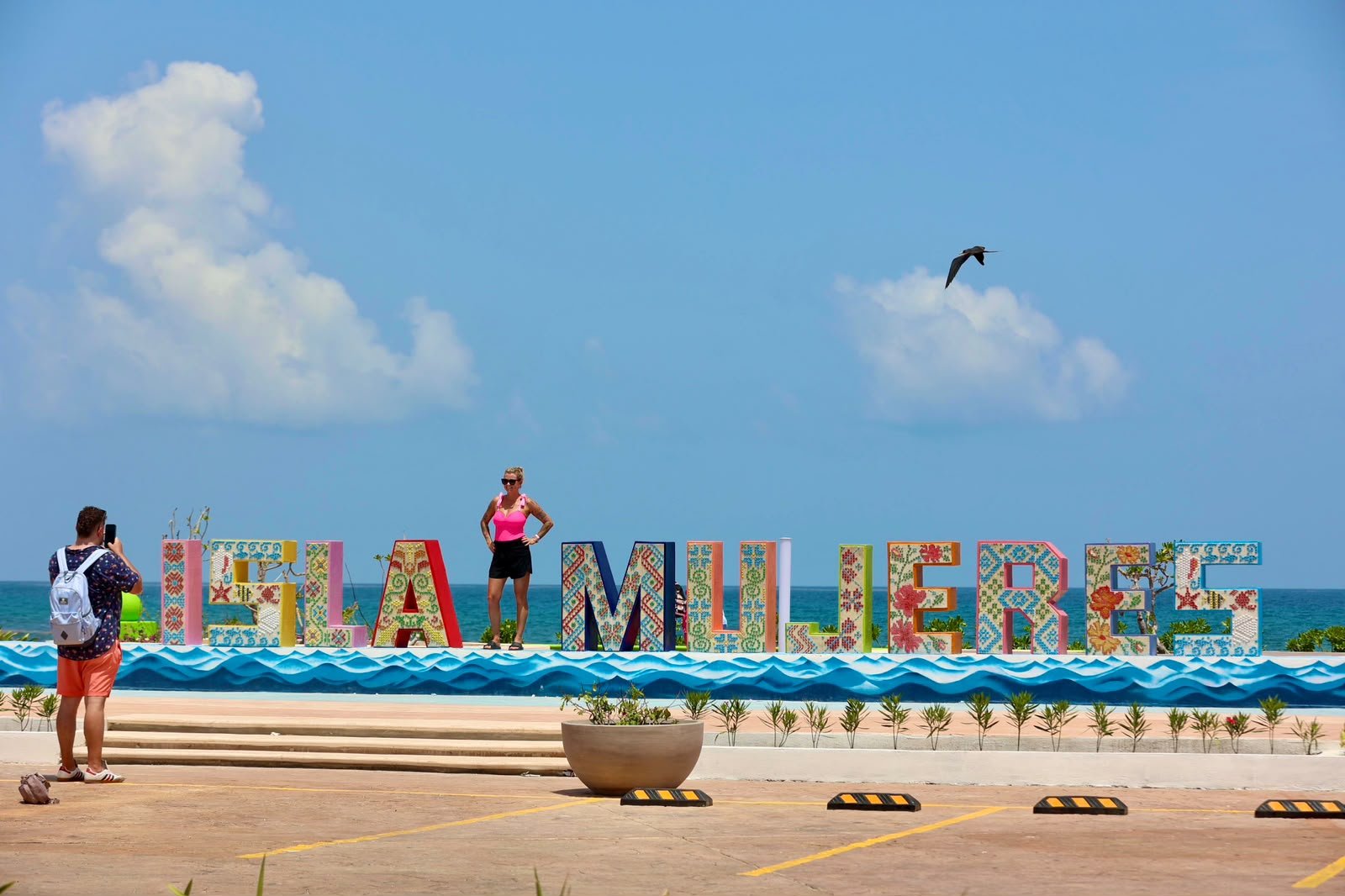 The Paseo de las Sirenas on the Malecón Oriente in Isla Mujeres, featuring mermaid sculptures facing the Caribbean Sea