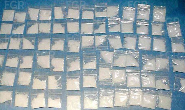 Federal police officers holding seized drugs during an operation in Playa del Carmen