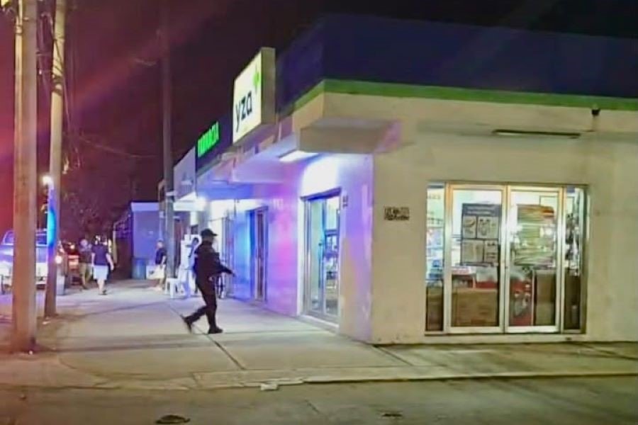 Police officers and investigators outside a pharmacy in Playa del Carmen after a robbery