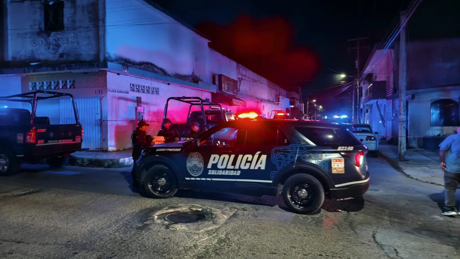 Police officers outside La Pigua bar in Playa del Carmen after a man was abducted by an armed group.