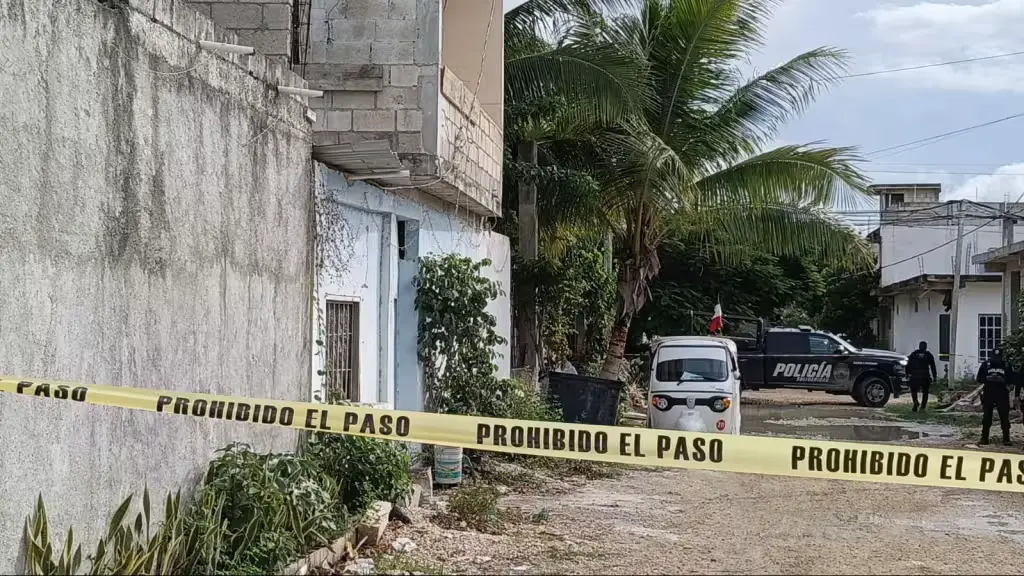 Police officers stand near the scene where a man was shot dead in an irregular settlement in Playa del Carmen, Quintana Roo