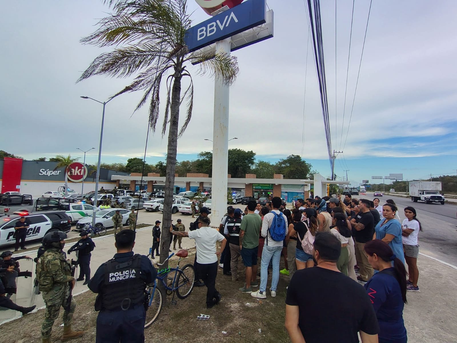 Police officers confront residents during a protest over persistent smoke in Puerto Morelos, Quintana Roo.