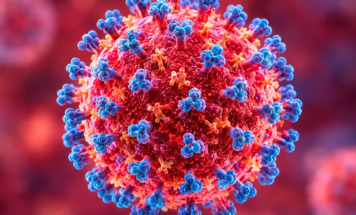 Illustration of measles virus particles alongside a vaccination syringe representing the measles outbreak in Quintana Roo, Mexico