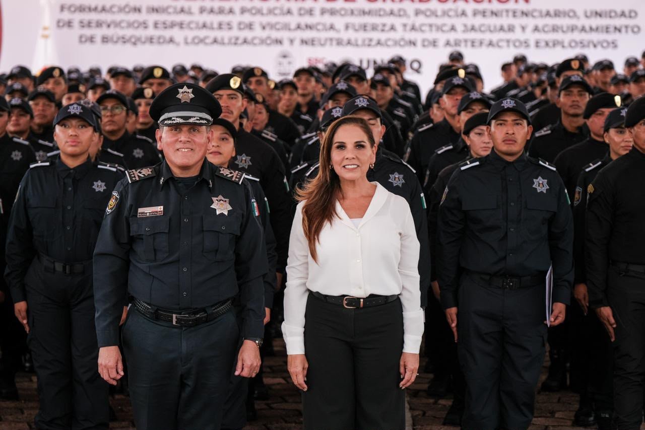 Newly graduated Quintana Roo state police officers stand in formation during a ceremony in Chetumal