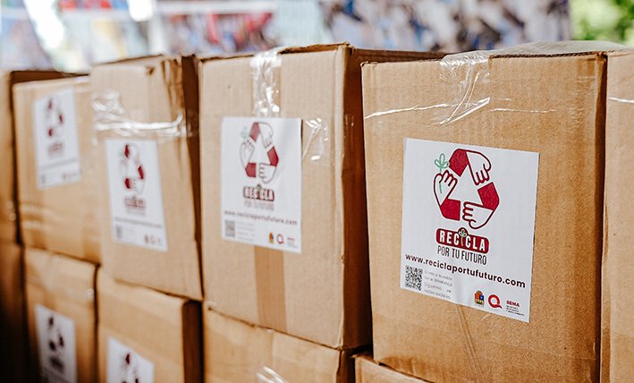 Bags of PET plastic bottles, aluminum cans and bundled cardboard ready for exchange at a recycling collection point in Quintana Roo