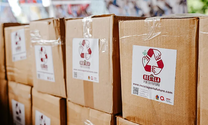 Bags of PET plastic bottles, aluminum cans and bundled cardboard ready for exchange at a recycling collection point in Quintana Roo