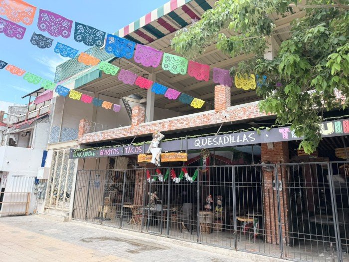 Pedestrians walk past storefronts and restaurants along Quinta Avenida in Playa del Carmen, Quintana Roo