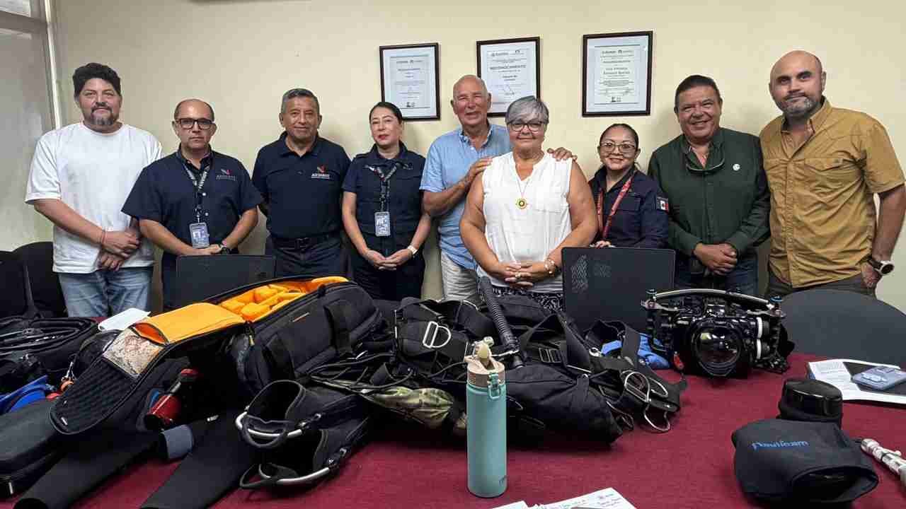 Scuba divers in full gear preparing to enter the water in Quintana Roo, Mexico, where officials are easing customs procedures for specialized diving equipment