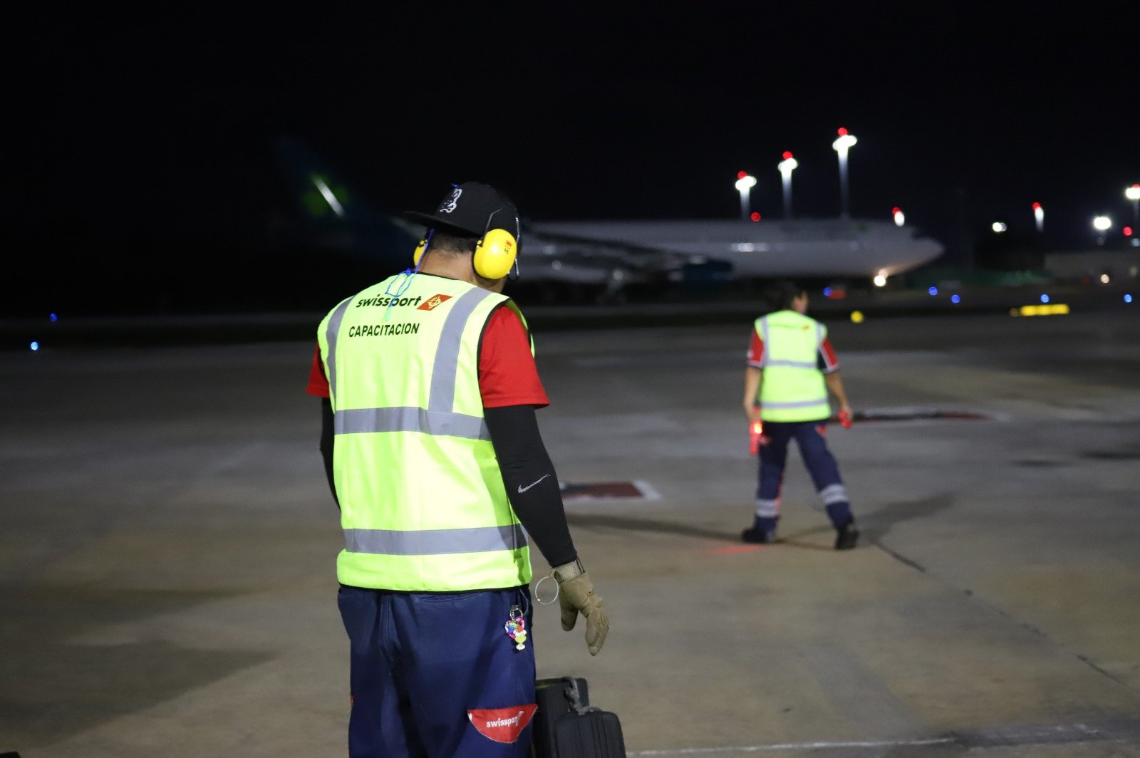 Travelers wait at Mexico City International Airport after a thunderstorm forced the suspension of takeoffs and landings, disrupting flights to and from Cancún