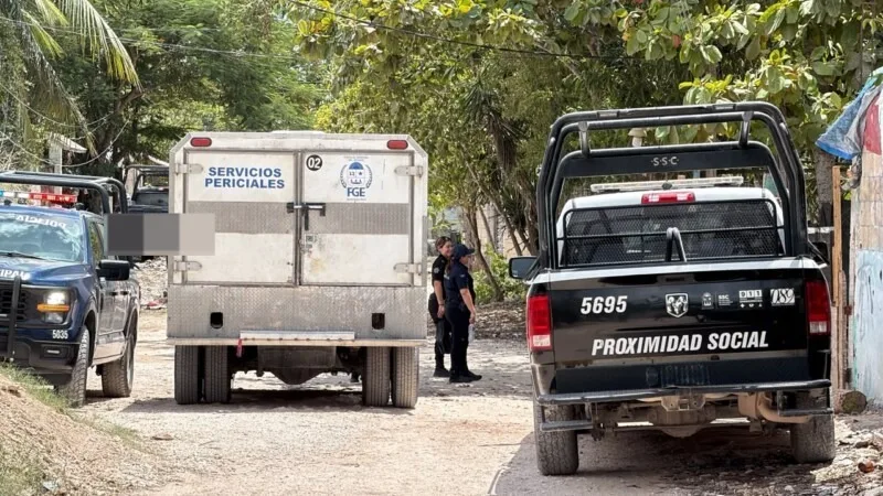 Police block a street near a Valle Verde home in Cancun where three bodies were found.