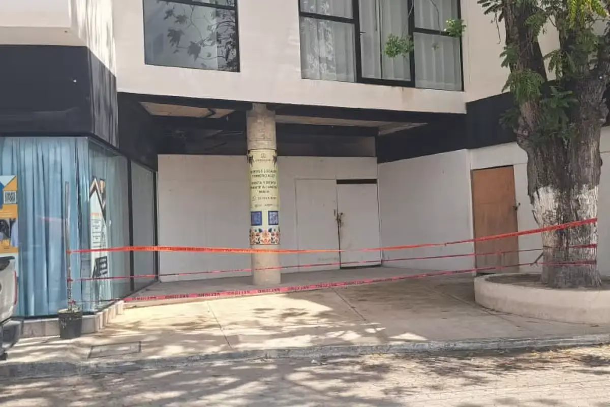 Bullet damage on the windows and facade of an office building on Calle Sol Poniente in Tulum, Quintana Roo