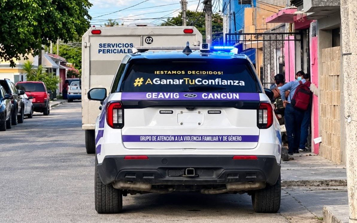 Police officers and emergency personnel outside homes in Cancún where two 13-year-old girls were found dead