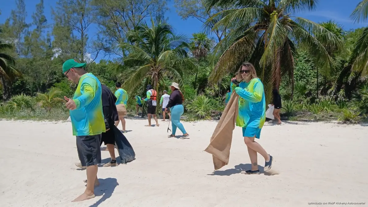 Volunteers and Zofemat workers gathering waste along the shore and in the water at Punta Esmeralda beach in Playa del Carmen, Quintana Roo