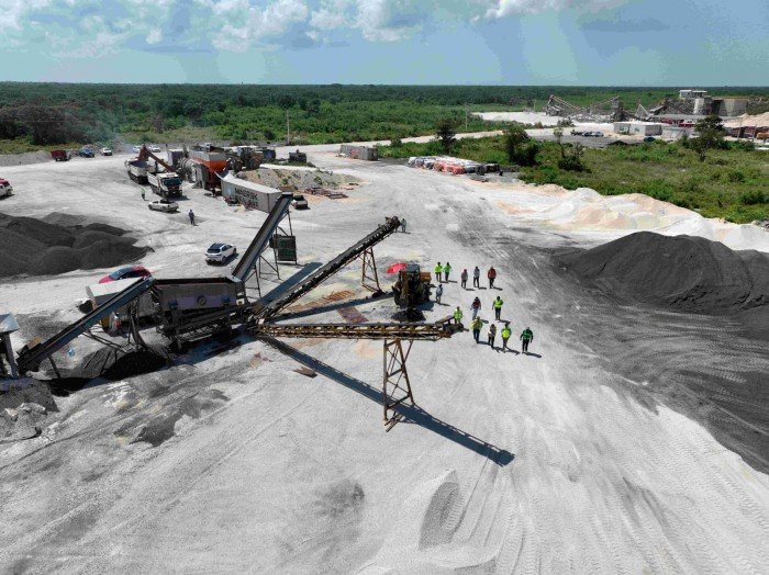 A road crew in Yucatan applies a new asphalt mix made from reclaimed pavement and tire rubber.