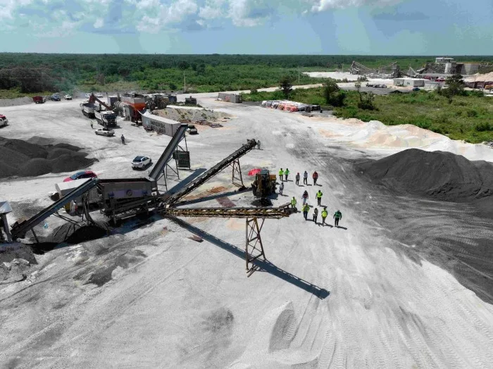 A road crew in Yucatan applies a new asphalt mix made from reclaimed pavement and tire rubber.