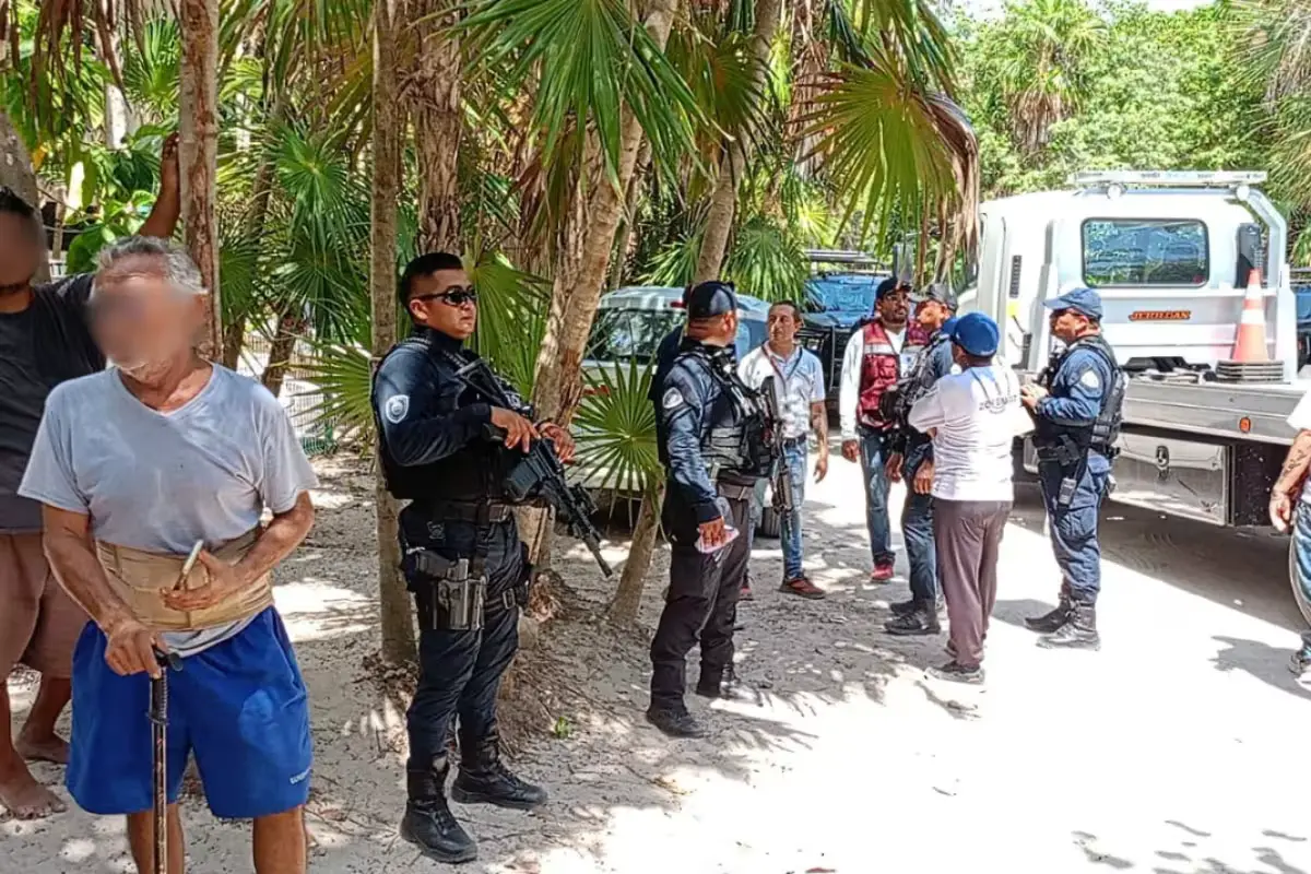 Zofemat personnel remove a barrier and secure jet skis and boats at a disputed beach access in Xcalacoco, Playa del Carmen.