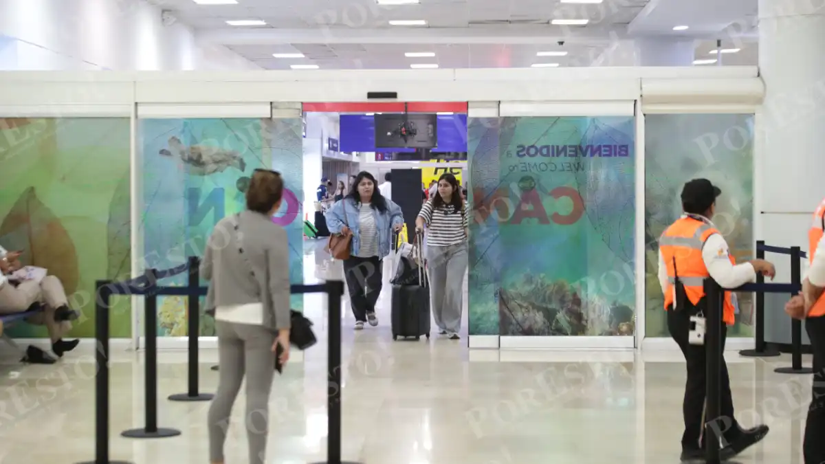 Travelers walking through the terminal at Cancún International Airport in Quintana Roo, Mexico