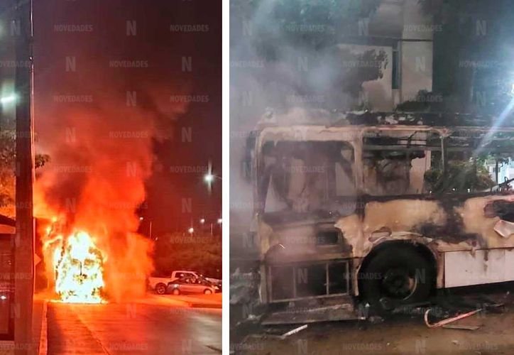 Firefighters work to extinguish flames from a public transport bus that caught fire on Avenida Tulum in Cancún
