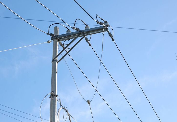 Electricity meters being installed on a street in a Cancún neighborhood as part of a municipal electrification project