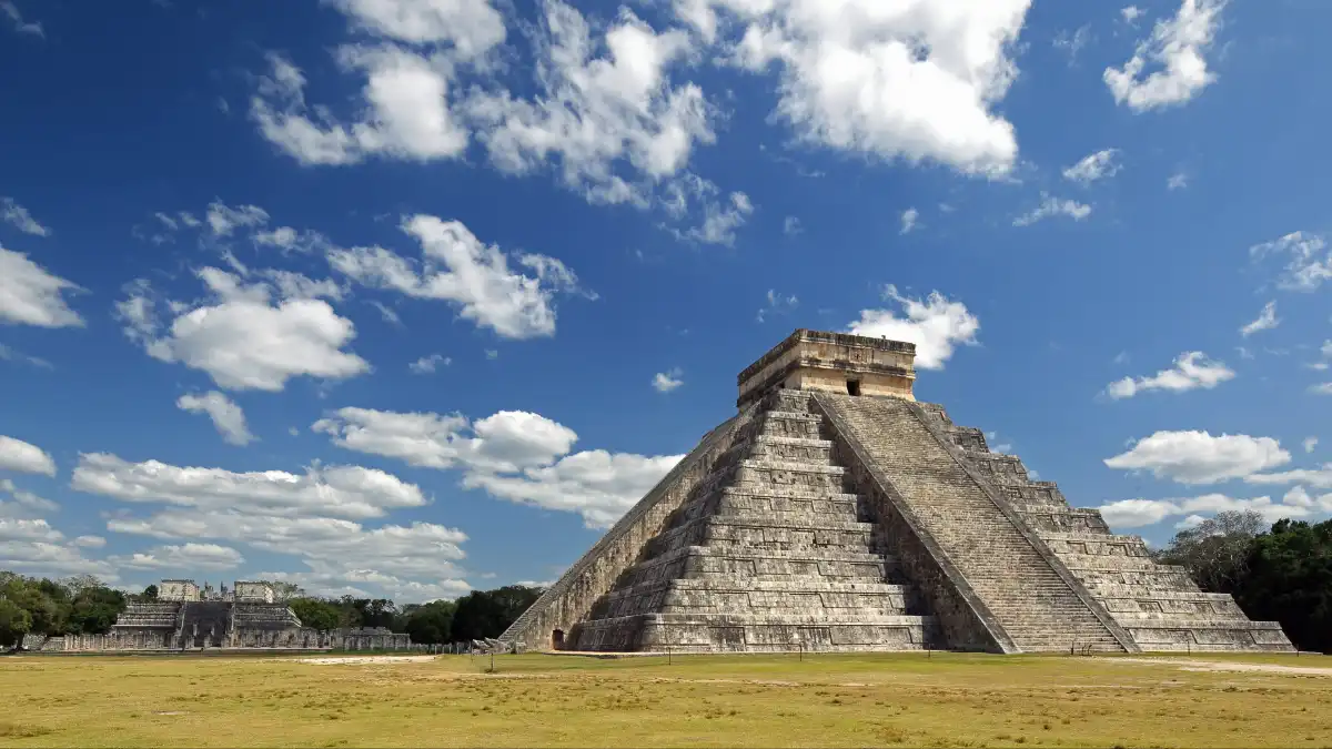Tourists walk among the stone pyramids and ruins of the Chichén Itzá archaeological site in Yucatán, Mexico