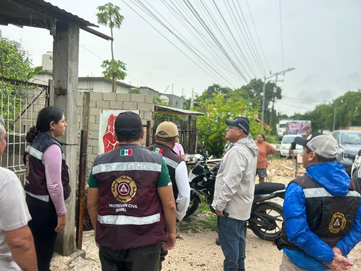 Civil protection and emergency workers pumping out standing water from flooded streets and homes in Bacalar, Quintana Roo