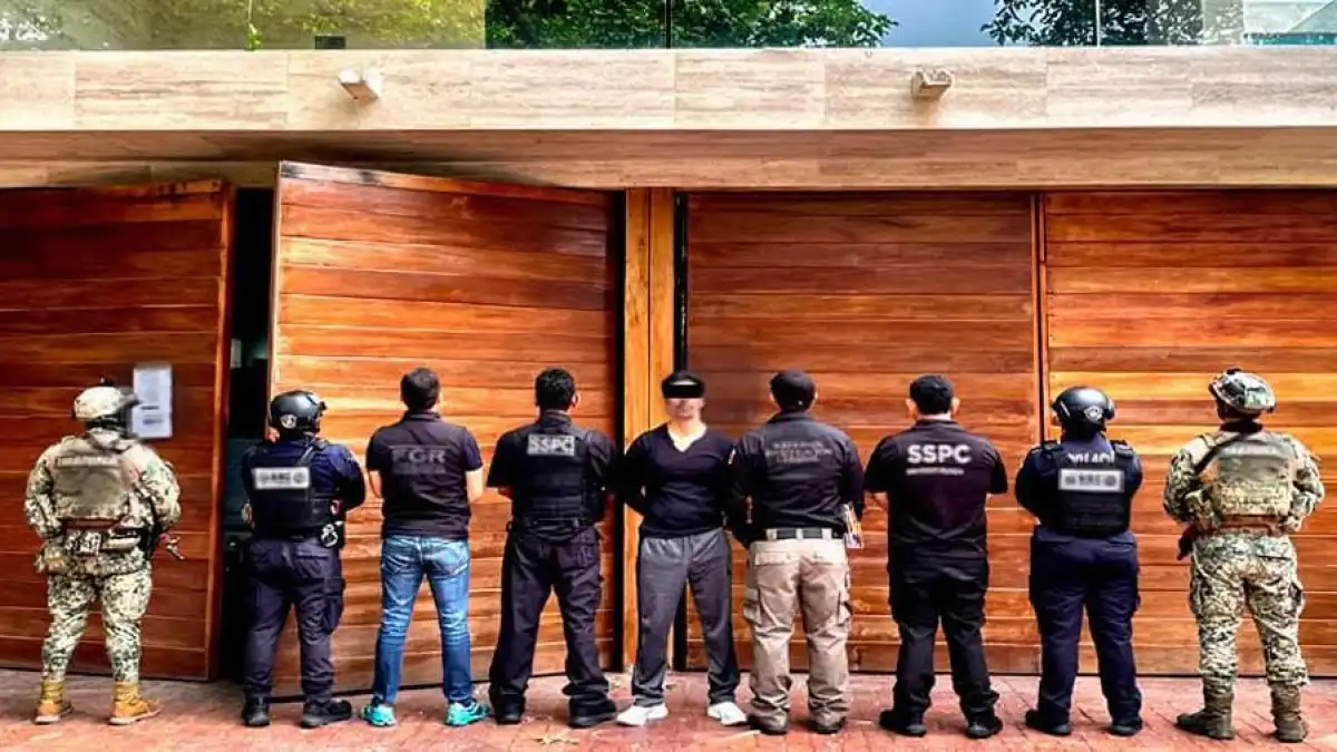 Security personnel stand guard during an operation in Playacar Fase 1, Playa del Carmen, where Sergio Rafael De Marcos Cruz was detained