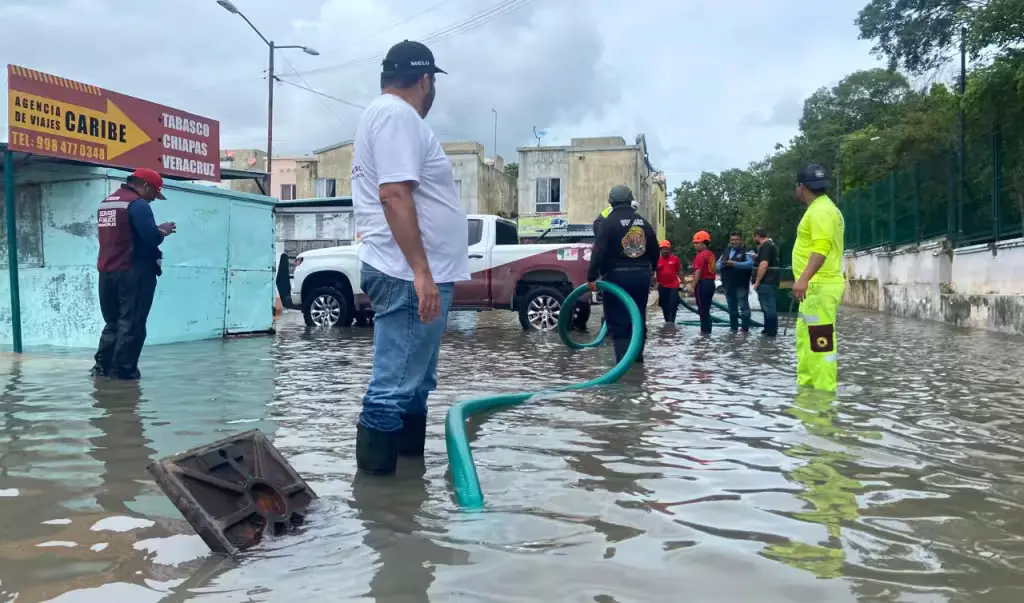 Flooded avenue with slow-moving traffic in Cancun after nearly 12 hours of rain from Tropical Wave 36