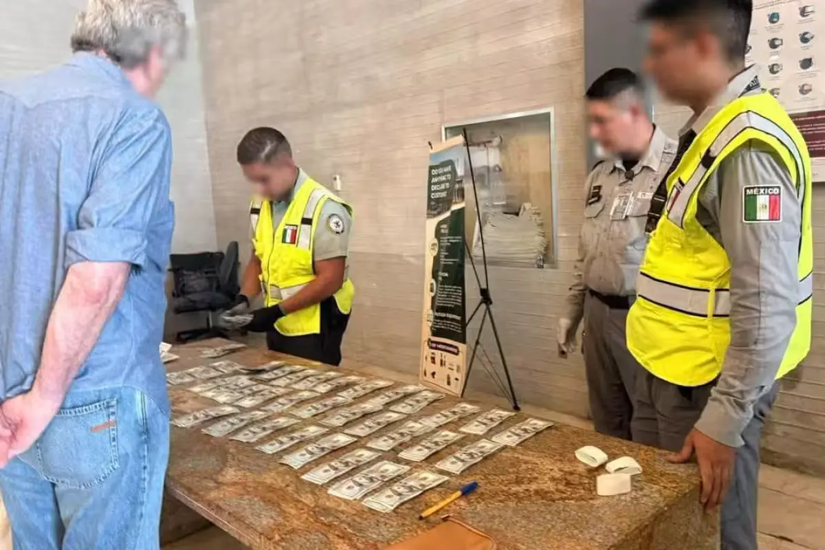 National Guard officers standing beside luggage screening equipment at Cancún International Airport, where a Brazilian tourist was detained over undeclared cash