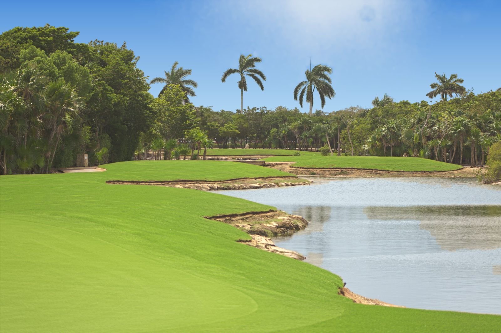 Golfers on the renovated nine-hole executive course at PGA Riviera Maya in Tulum Country Club