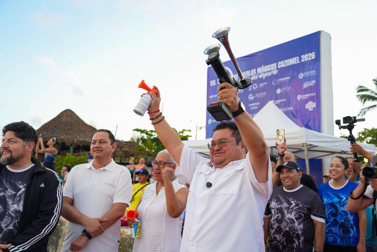 Athletes and officials celebrate on the podium at the first Pueblos Mágicos Triathlon in Cozumel