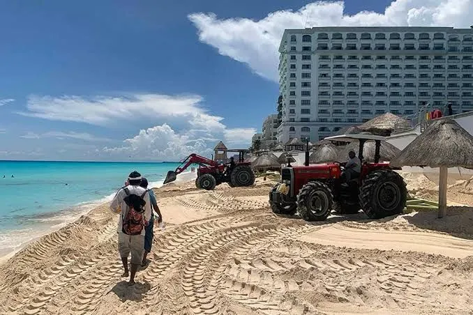 Long stretch of white sand beach meeting turquoise Caribbean water on the Quintana Roo coast