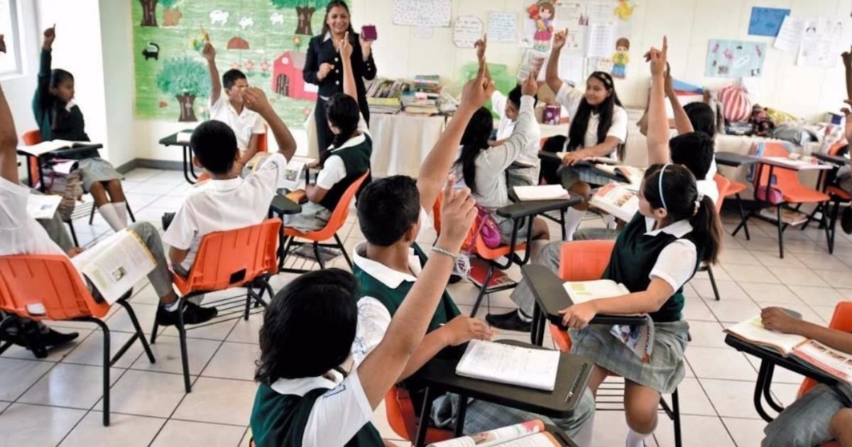 Students sitting at desks in a classroom in Quintana Roo, Mexico, ahead of a scheduled October school closure