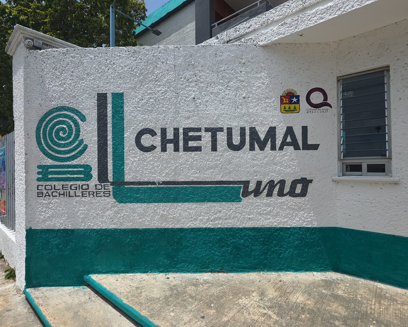 Surveillance camera mounted on a building wall at a high school campus in Quintana Roo